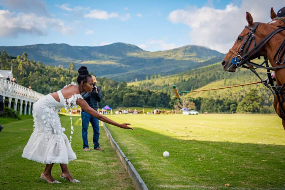 lady throwing a polo ball back onto the field