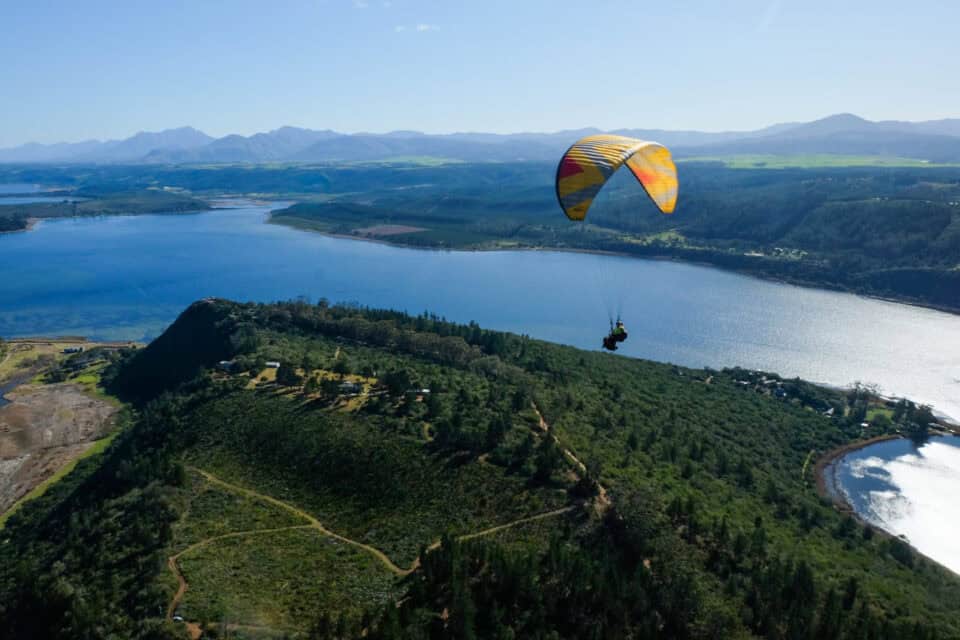 powered parachute flying over beautiful garden route scenery