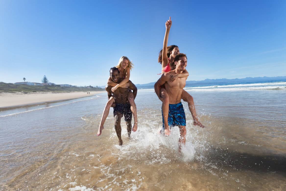 two couples on a beach on the Garden Route